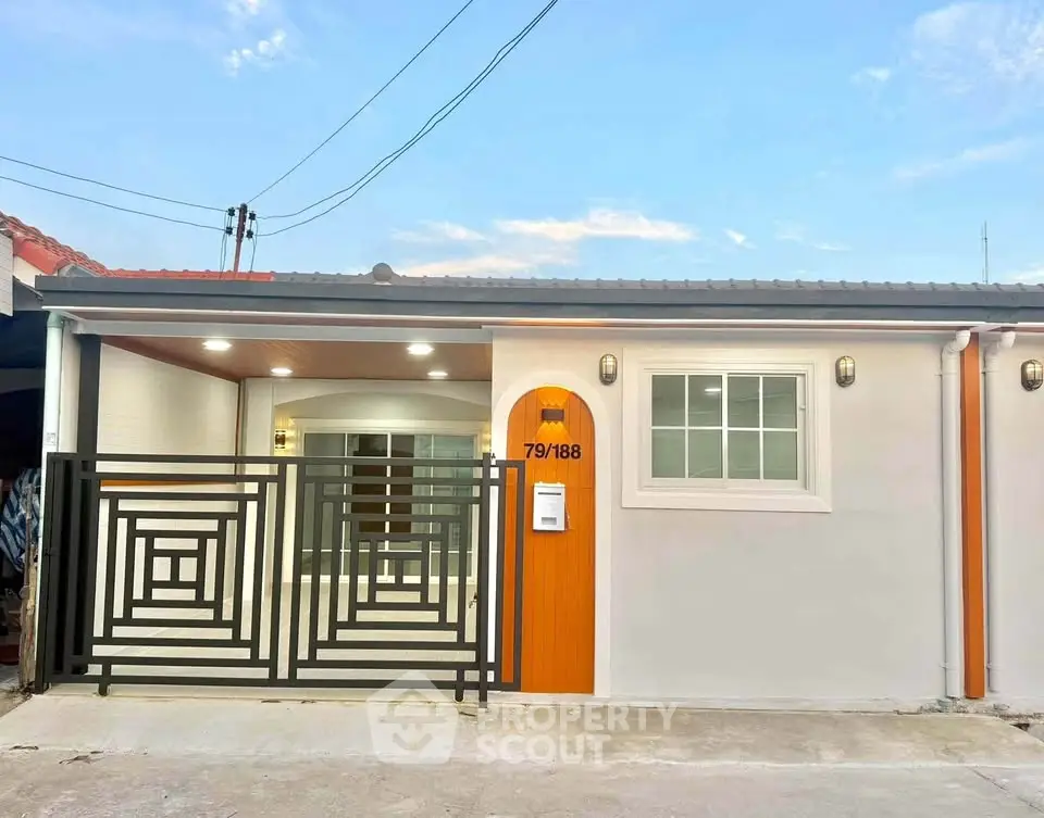 Charming single-story home with modern facade and stylish gate, perfect for cozy living.