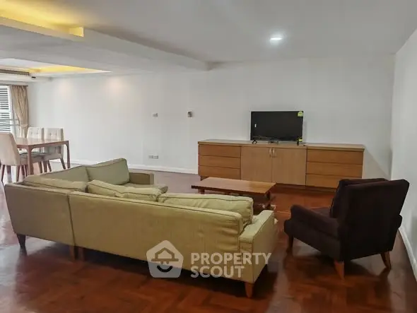 Spacious living room with modern furniture and wooden flooring