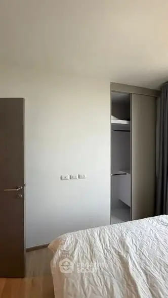 Modern bedroom with minimalist design and built-in closet