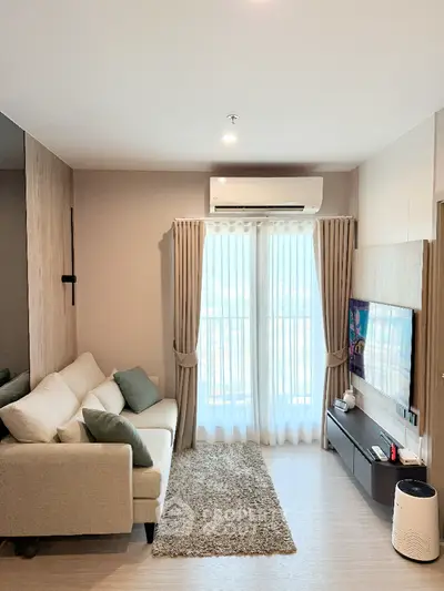Modern living room with cozy sofa and large window for natural light