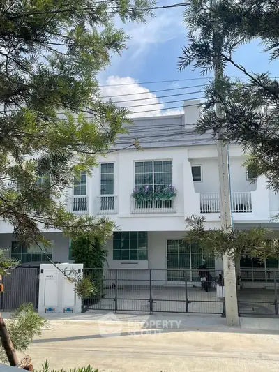 Charming modern townhouse with lush greenery and spacious driveway