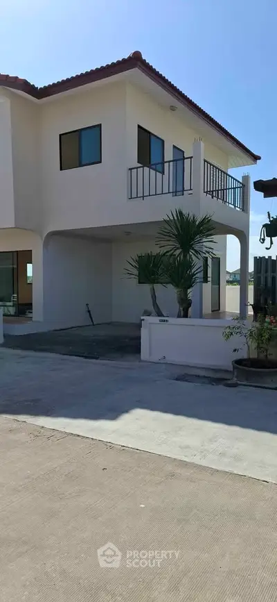 Charming two-story house with balcony and modern design in a serene neighborhood.