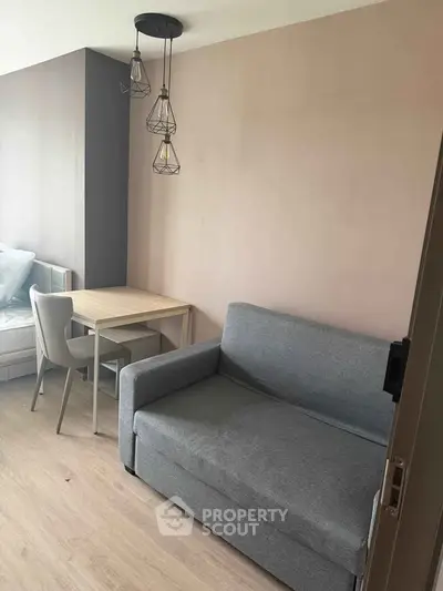 Cozy living room with modern sofa and dining area, perfect for urban living.