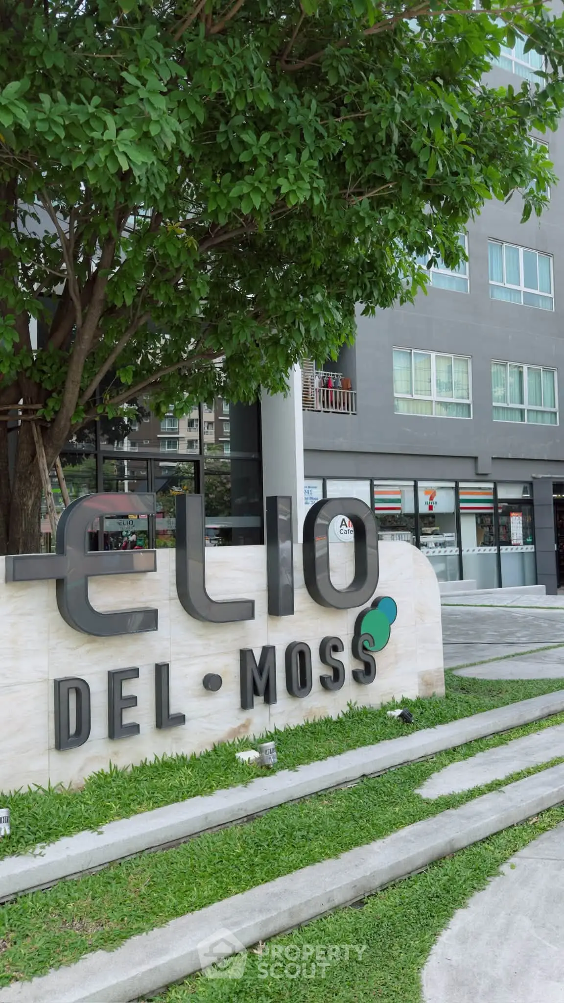 Modern condominium building with lush greenery at Elio Del Moss.