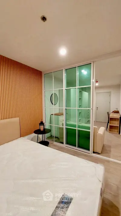 Modern bedroom with glass partition and stylish wooden paneling