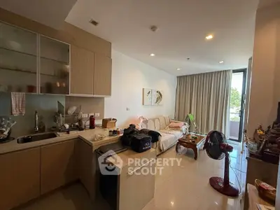 Modern living room with open kitchen layout and natural light