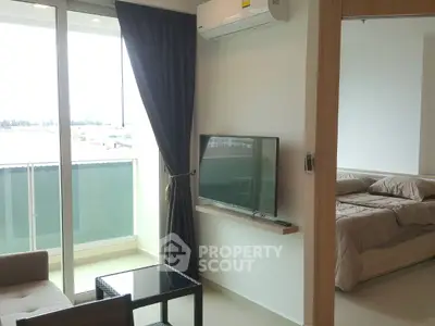 Modern apartment with balcony, living room, and bedroom view