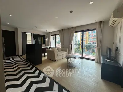 Spacious modern living room with balcony and stylish flooring