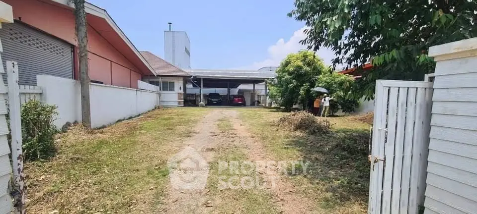 Spacious residential property with driveway and carport, ideal for development.