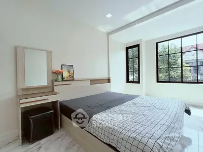 Bright and airy bedroom with modern decor and large windows