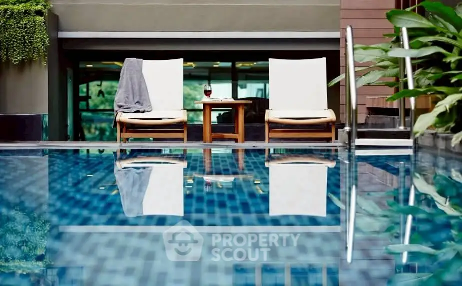 Luxurious poolside view with elegant lounge chairs and serene ambiance