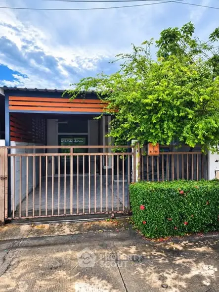 Charming single-story home with lush greenery and modern facade, perfect for serene living.