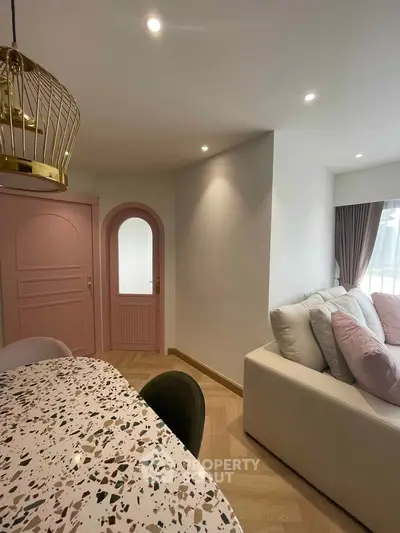 Chic modern living room with terrazzo table and pastel pink accents