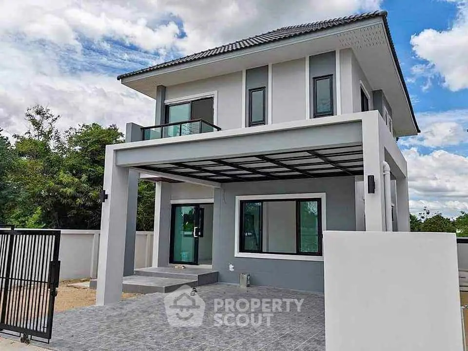 Modern two-story house with sleek design and spacious balcony in a serene neighborhood.