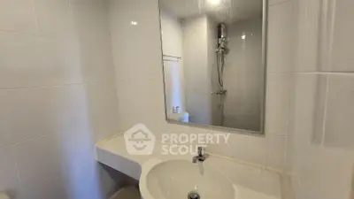 Modern bathroom with sleek white tiles and stylish fixtures
