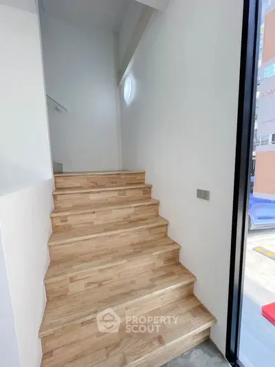 Modern wooden staircase with natural light and sleek design