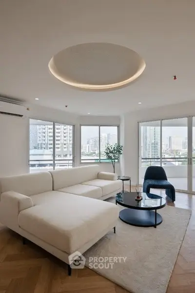 Luxurious modern living room with elegant furniture and stunning city view.