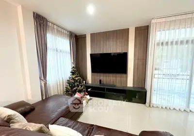 Modern living room with sleek TV setup and holiday decor