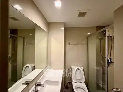 Modern bathroom with sleek fixtures and glass shower enclosure