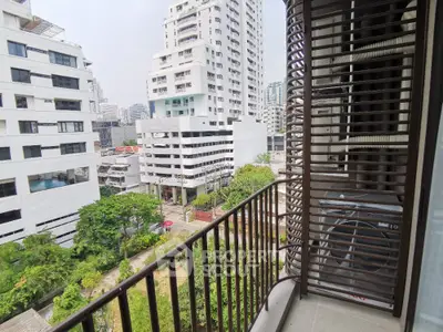 Modern urban balcony with city view and lush greenery