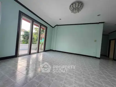 Spacious empty room with large windows and tiled floor, perfect for customization.