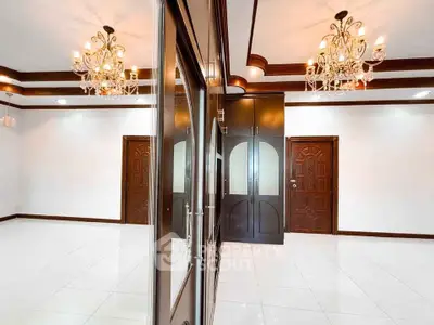 Elegant interior with chandeliers and wooden accents in spacious room