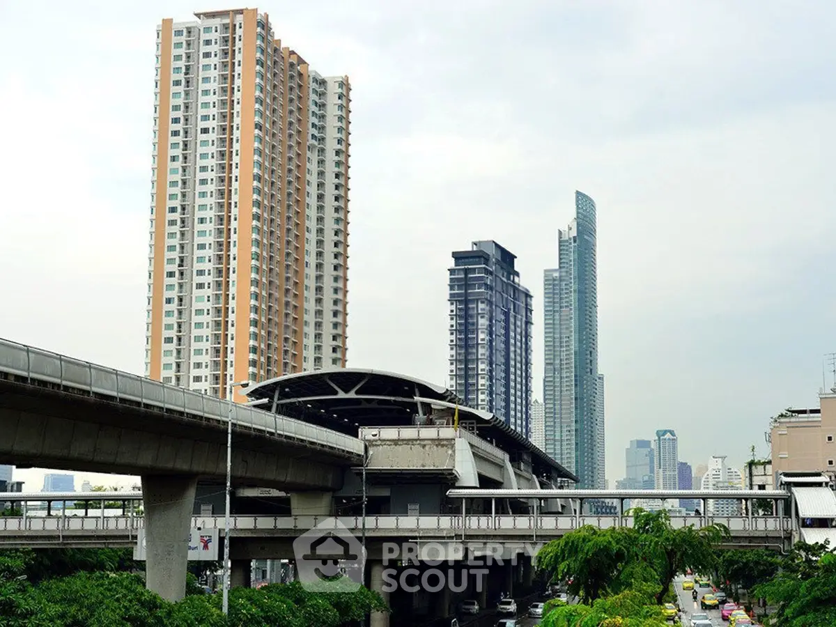 Stunning urban skyline with modern high-rise buildings and elevated train tracks, showcasing vibrant city living.