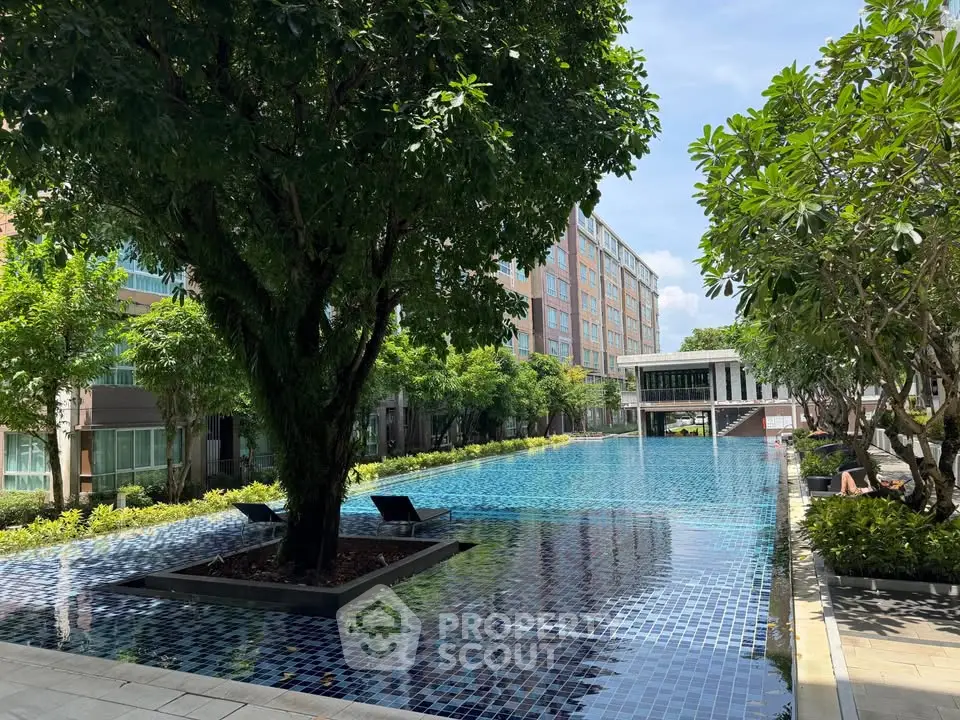 Luxurious residential pool area with lush greenery and modern architecture