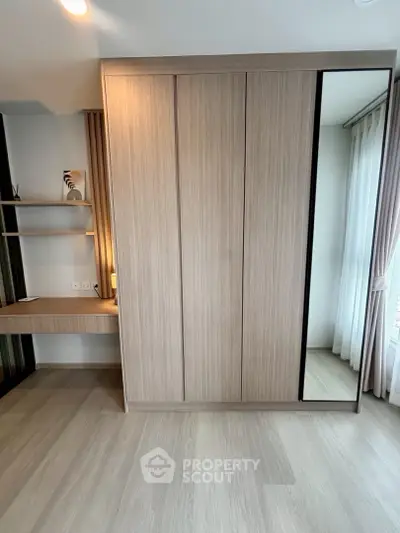 Modern bedroom with sleek built-in wardrobe and natural light