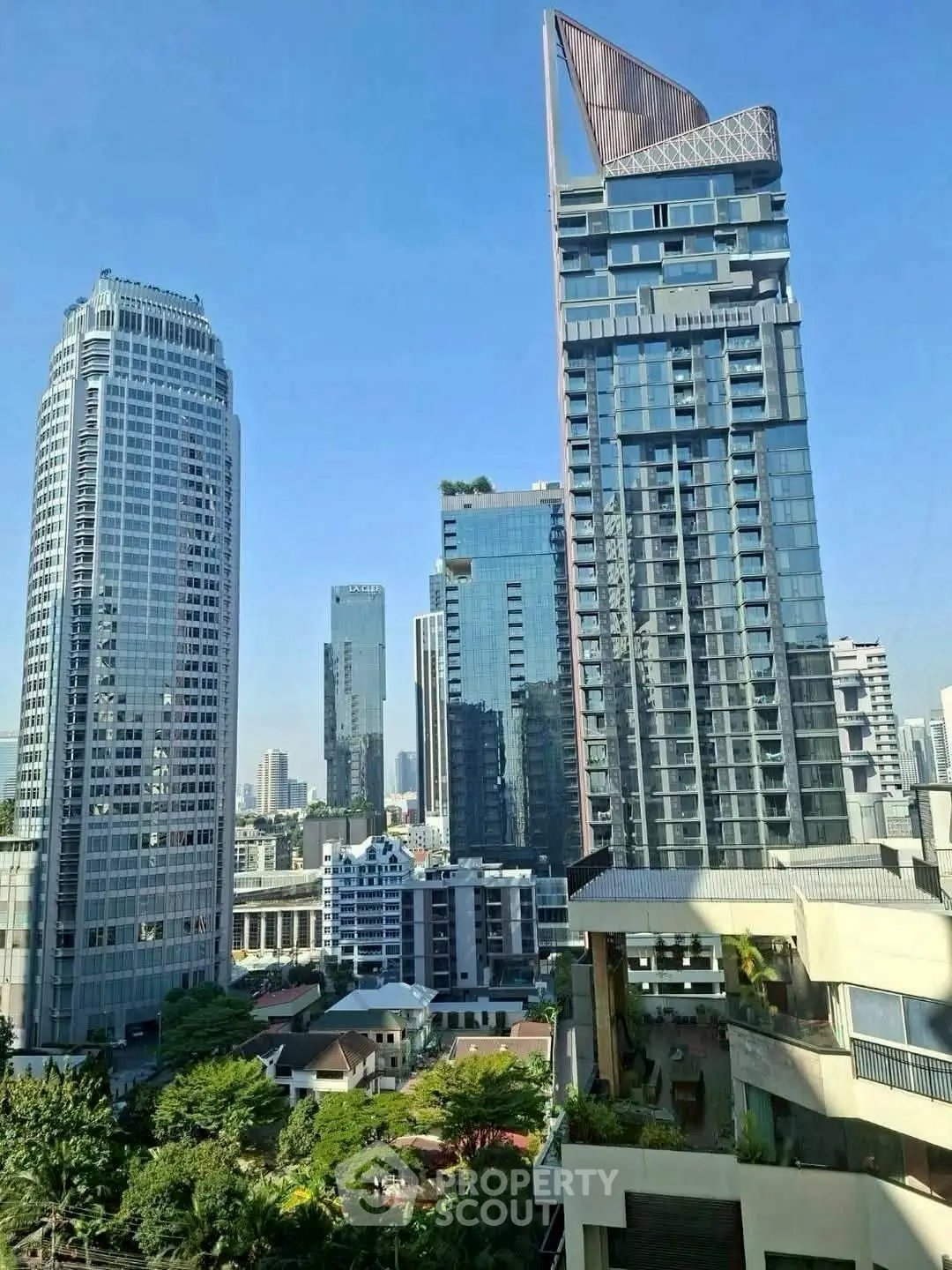 Stunning cityscape view featuring modern high-rise buildings and lush greenery, perfect for urban living.