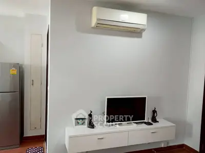 Modern living room with wall-mounted TV and air conditioning unit
