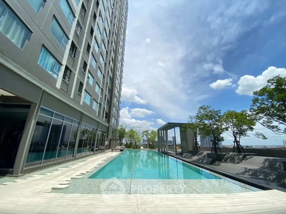 Luxurious high-rise building with stunning rooftop pool and city views.