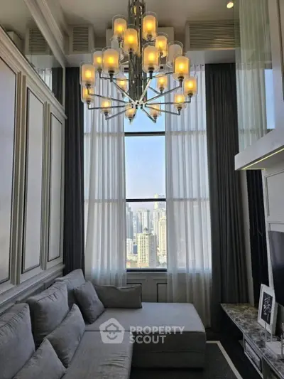 Luxurious high-ceiling living room with elegant chandelier and stunning city view.