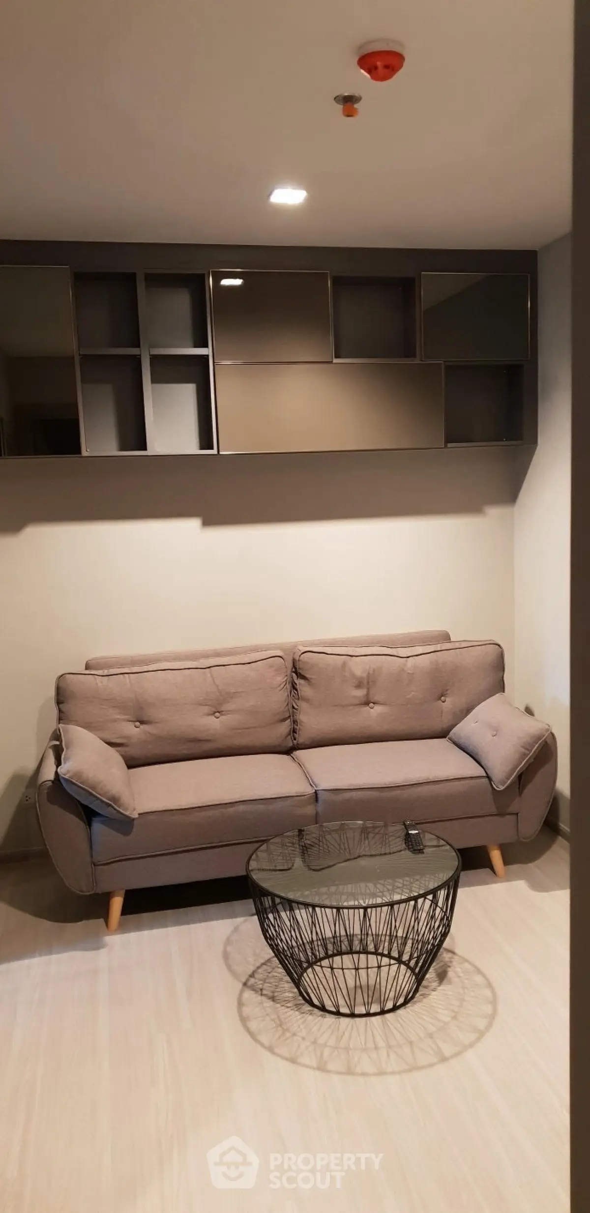 Modern living room with stylish sofa and unique coffee table in a cozy apartment setting.
