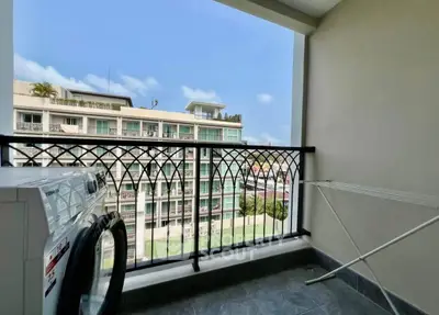 Charming balcony with laundry area and scenic city view, perfect for urban living.