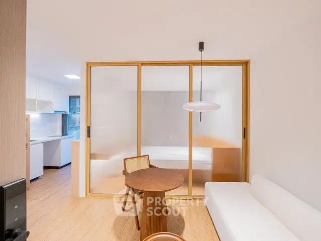 Modern minimalist living room with sliding doors and cozy seating area