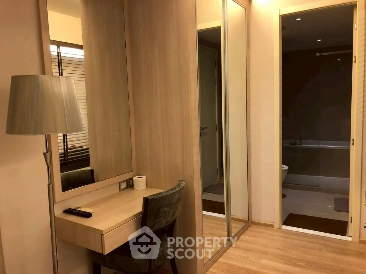 Elegant bedroom with mirrored wardrobe and cozy workspace