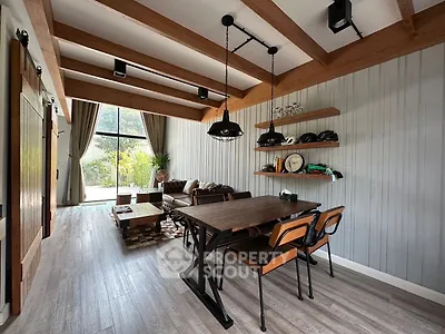 Stylish living room with wooden beams and modern furniture, perfect for cozy gatherings.