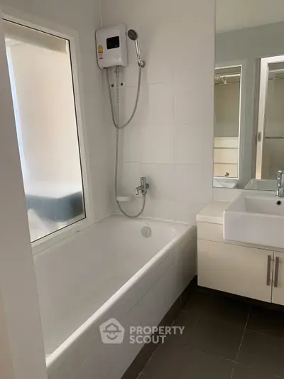Modern bathroom with bathtub and sleek fixtures in a contemporary home.