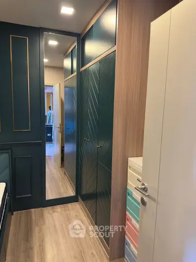 Stylish bedroom with modern closet and full-length mirror