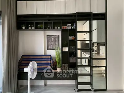Modern loft-style apartment with mezzanine, sleek kitchen, and cozy living area.