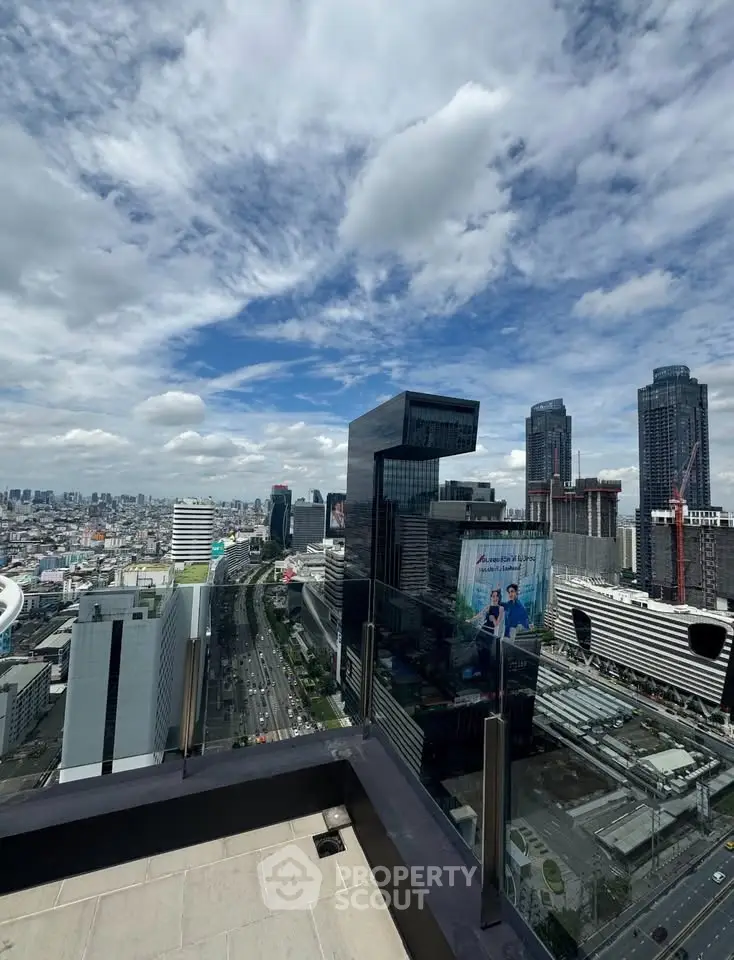 Stunning cityscape view from a high-rise balcony showcasing modern architecture and vibrant skyline.