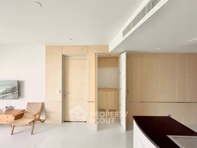 Modern minimalist living room with sleek wooden paneling and stylish furniture