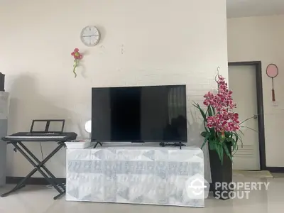 Modern living room with TV, keyboard, and elegant decor