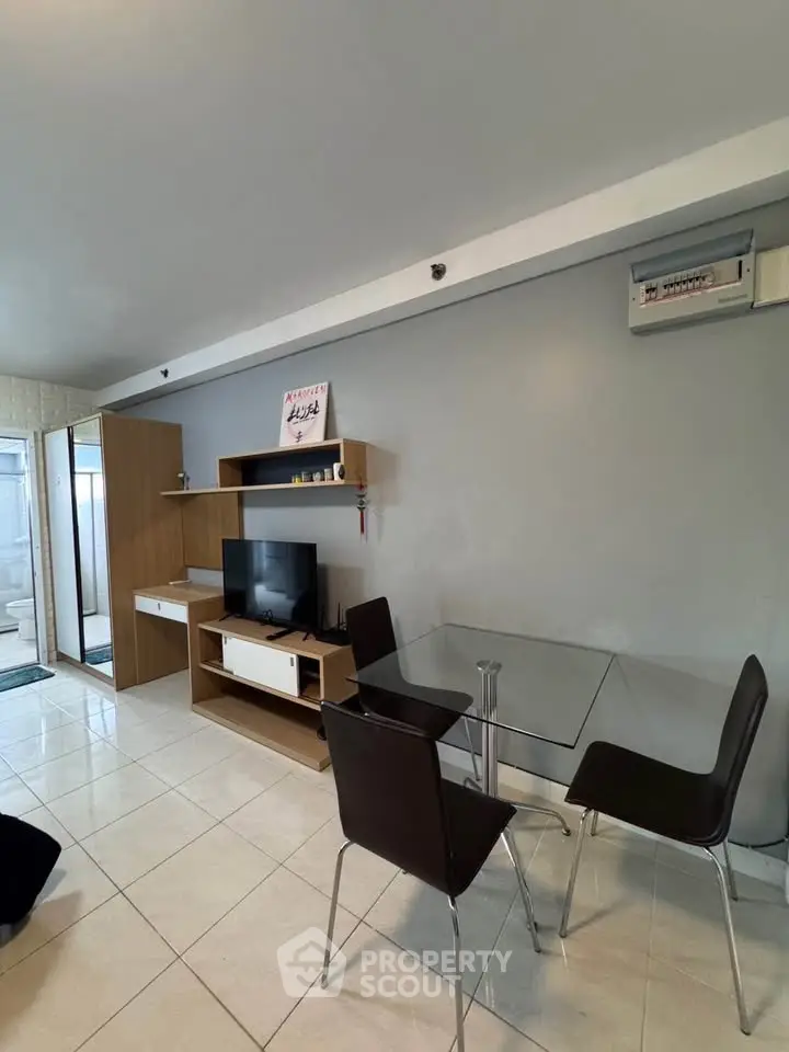 Modern living room with sleek furniture and wall-mounted TV in a stylish apartment.