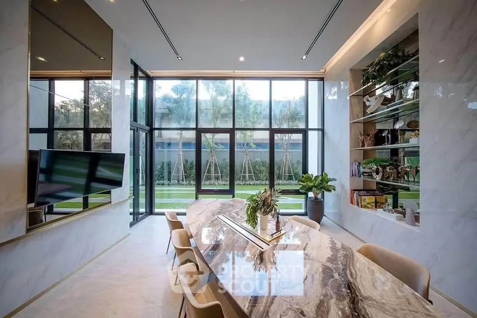 Luxurious modern living room with marble table and garden view, perfect for elegant gatherings.