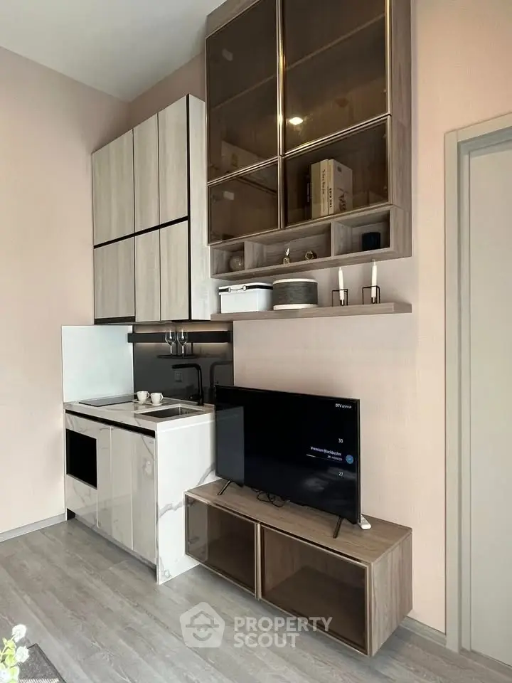 Modern compact kitchen with sleek cabinetry and integrated appliances