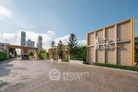 Luxurious entrance of The Sky Sukhumvit with modern architecture and lush greenery.