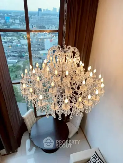 Luxurious chandelier in elegant high-rise apartment with stunning city view