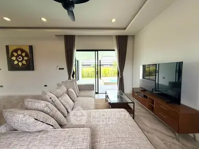 Spacious modern living room with pool view and stylish decor